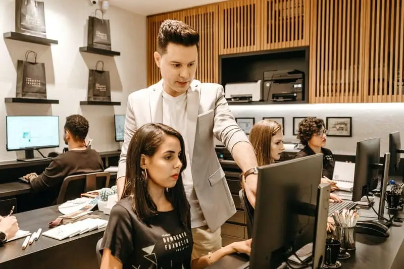 How-Salesforce-Metadata-Affects-Compliance-1 Man and Woman Working Together on Computer_AutoRABIT