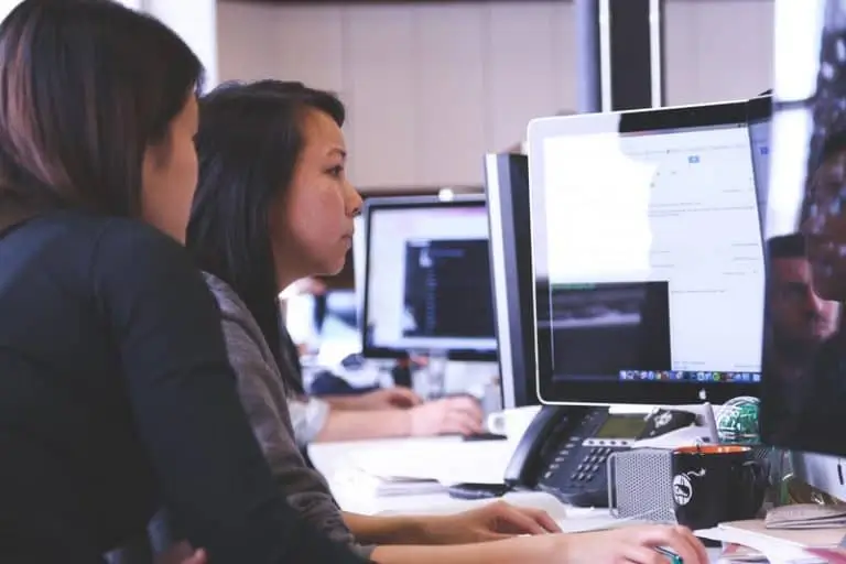 People working in an office on a computer_AutoRABIT