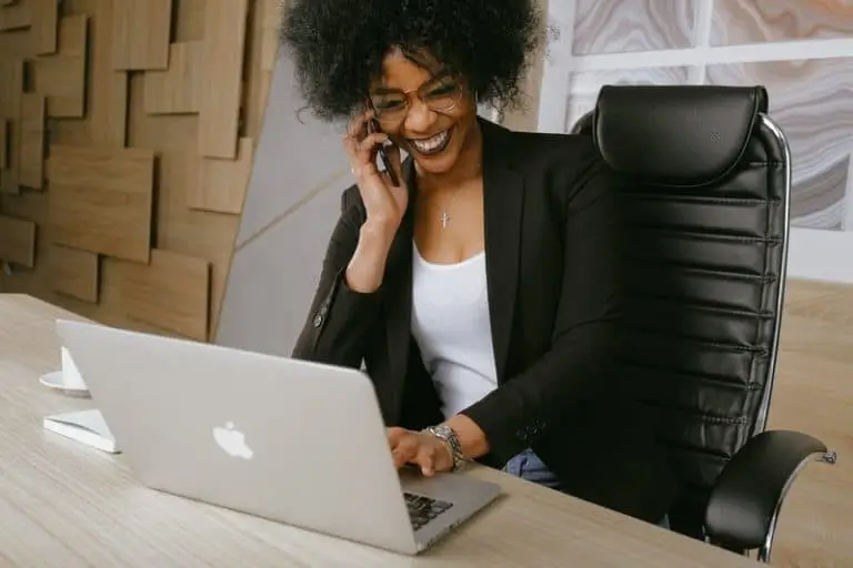 How-Frequent-Updates-Help-Keep-up-With-the-Financial-Industry-1-768x512-1 Woman using phone and computer_AutoRABIT