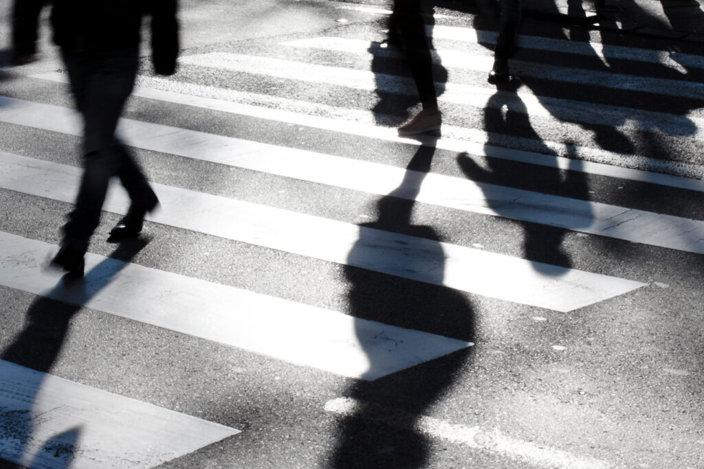 Blurry zebra crossing with pedestrians making long shadows Why Salesforce Deployment Challenges Hit Public Sector Teams Harder_AutoRABIT